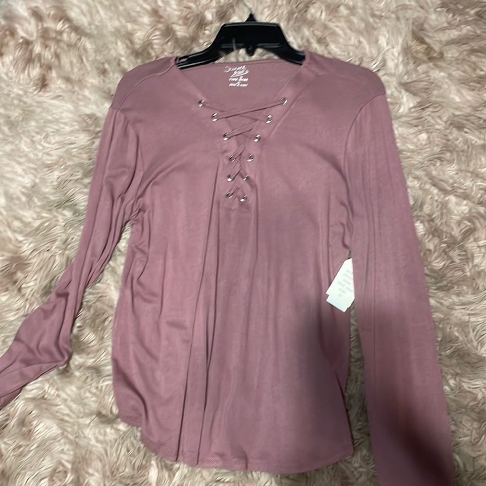 Brand new long sleeve with The neck line cross crossed .